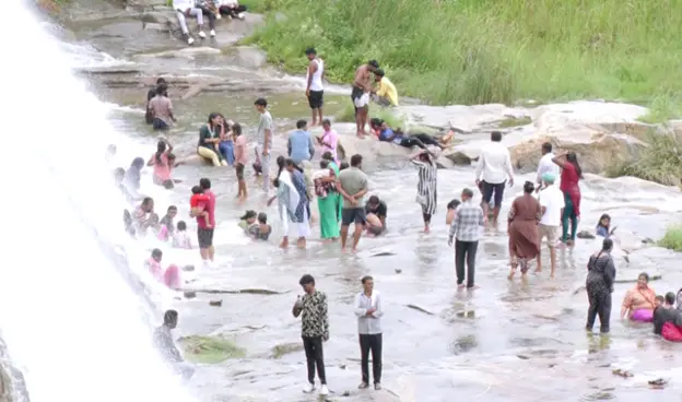 Girls Place Feet on Ganga Idol at Srinivasa Sagar Reservoir