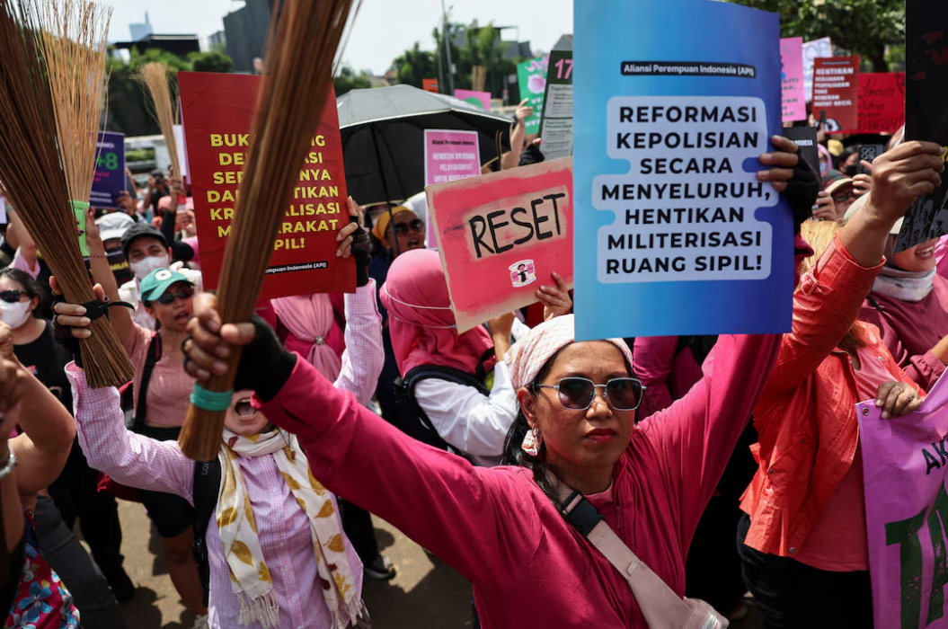 Hundreds of Women join protests with brooms as Indonesia leader flies to China